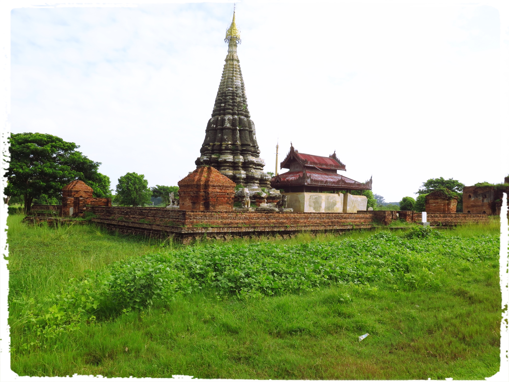 The spired stupa is the Lawka Dawtha Man Aung Pagoda. The Pagoda encloses a small shrine with a statue of Buddha in a small building nearby. The Pagodas house relics but not always one is able to find original relics and house them. Many Pagodas have housed replica of the relics and have drawn the faithful.