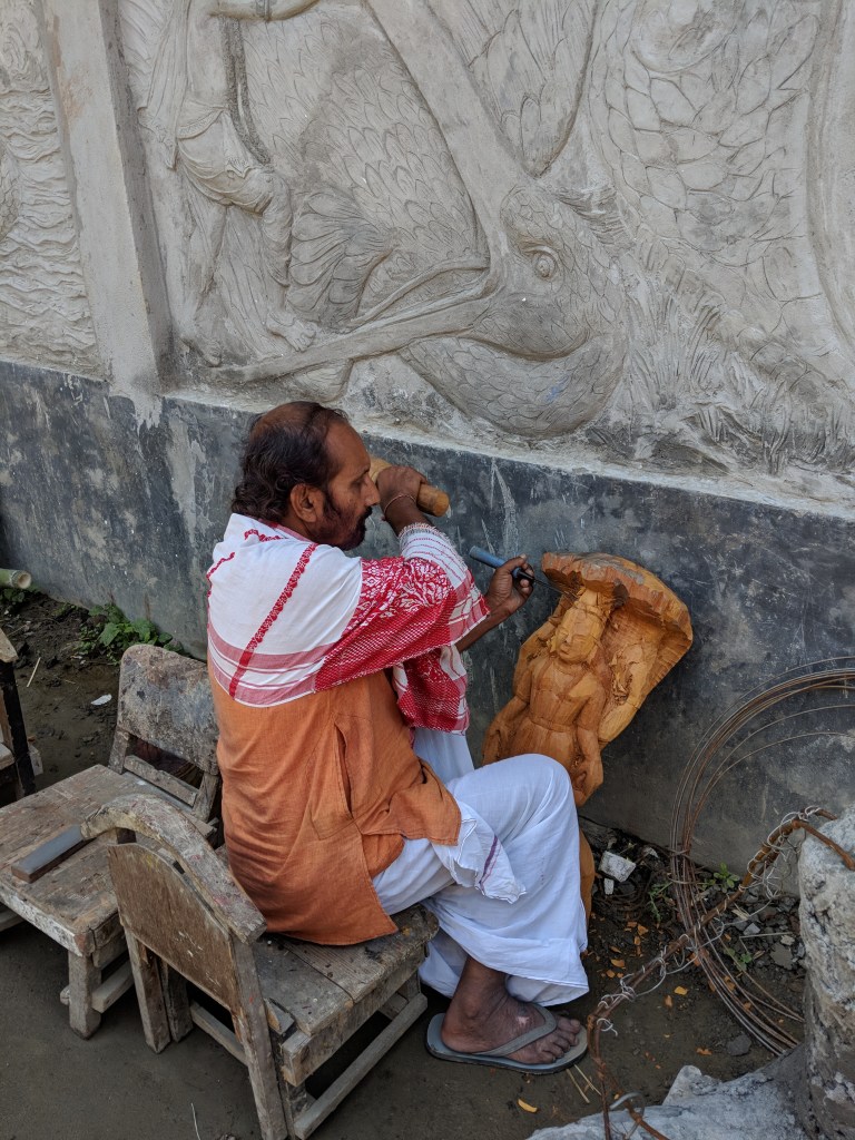 Guru Hemchandra Goswami at work on a wooden scultpture