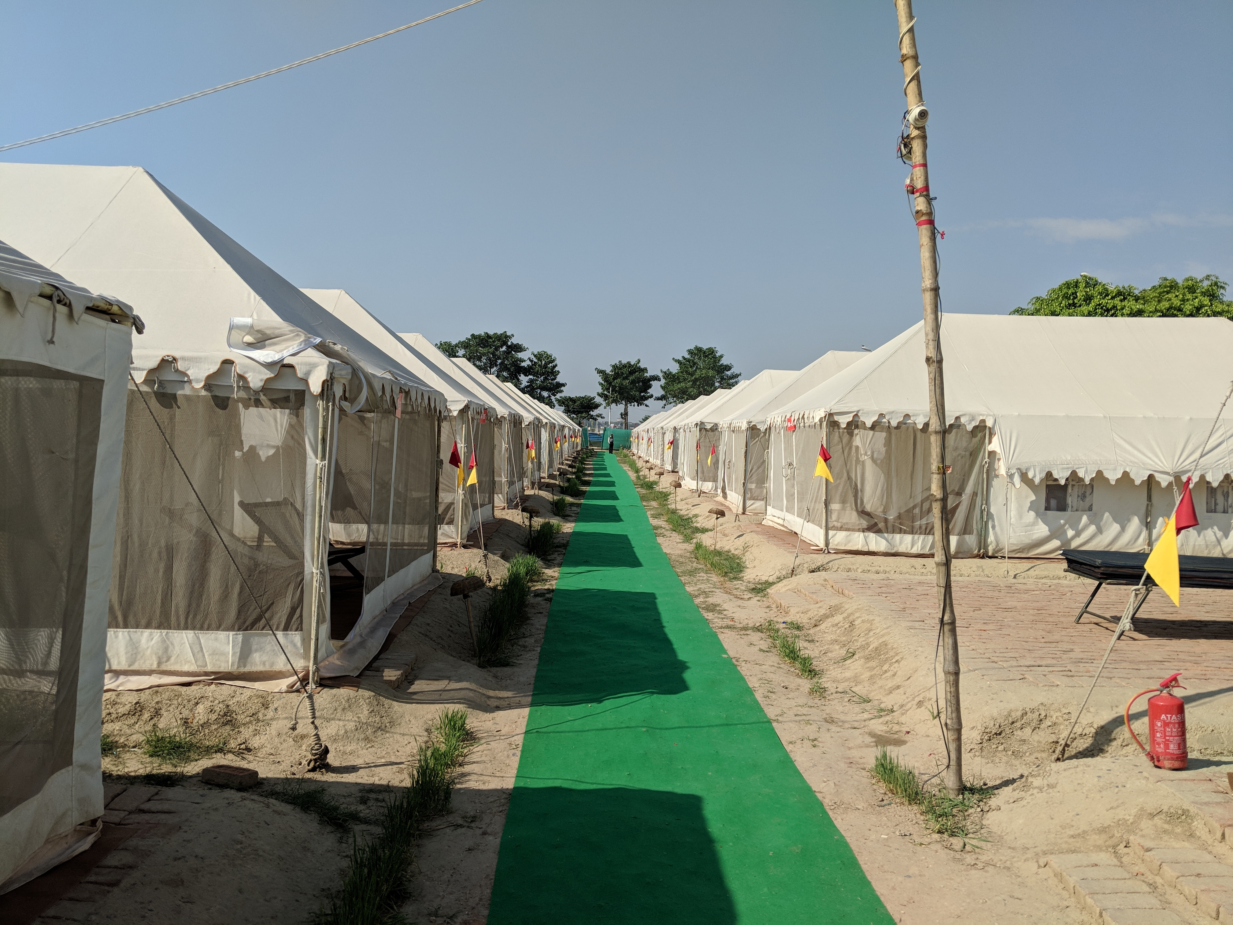 The Tent city with a green carpet, tents and fire fighting equipment