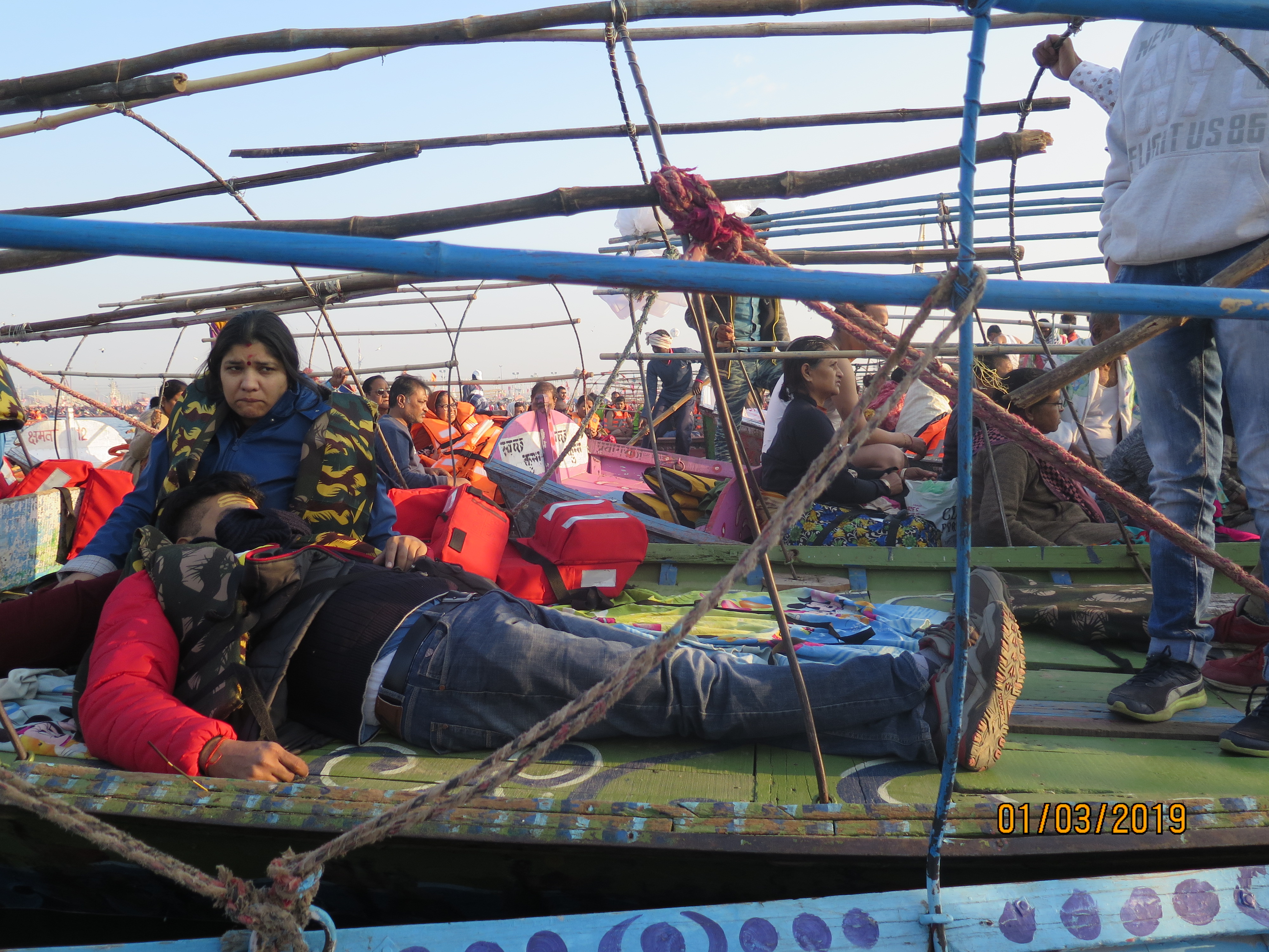 Man sleeping on the boat on the lap of his wife