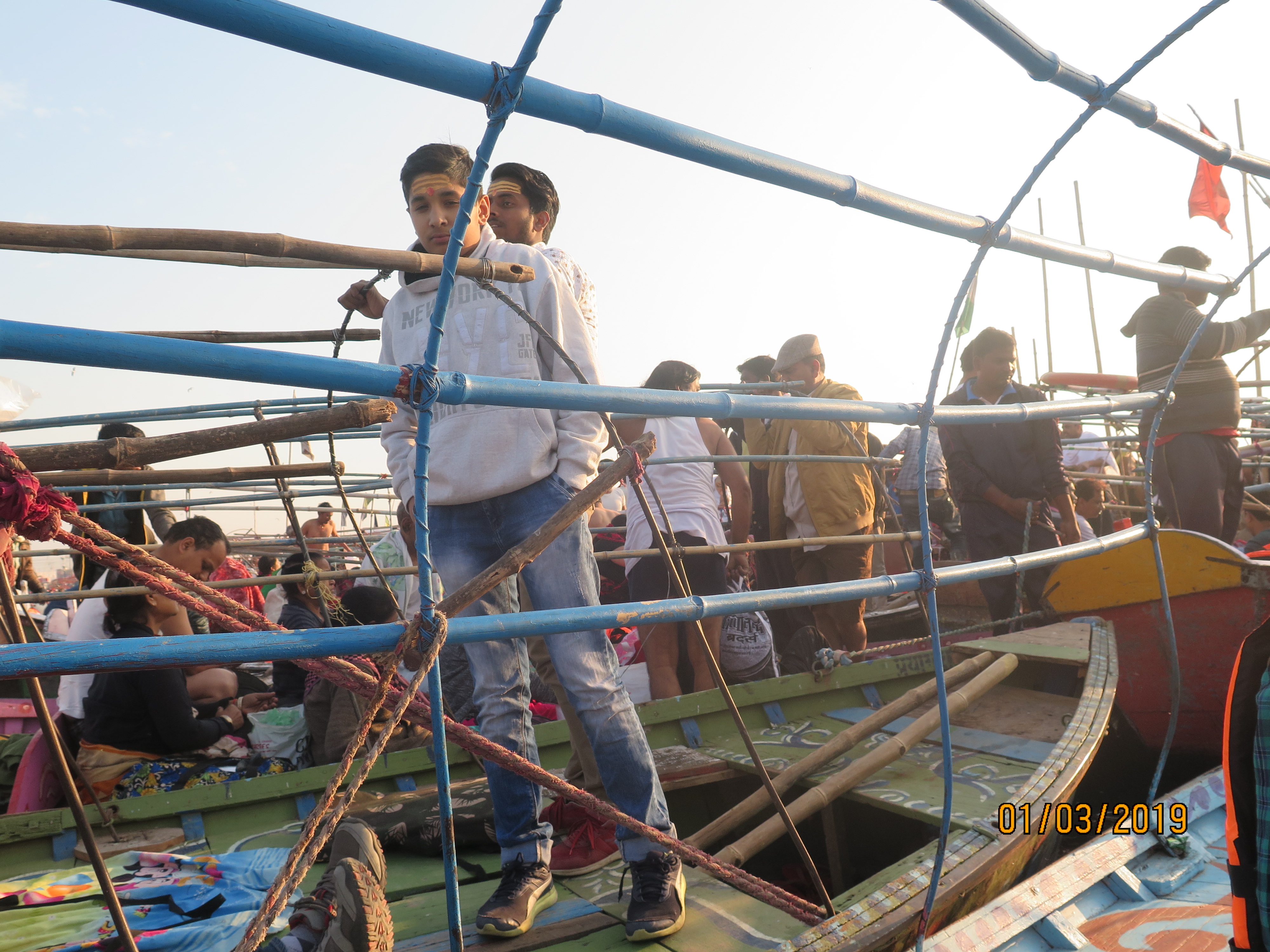 Faithfuls smeared with vermillion paste by priests who conduct prayers at the sangam