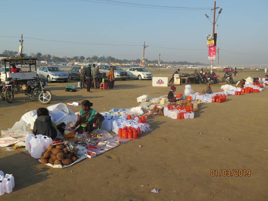 Sellers of water cans and coconuts on the banks of Ganges