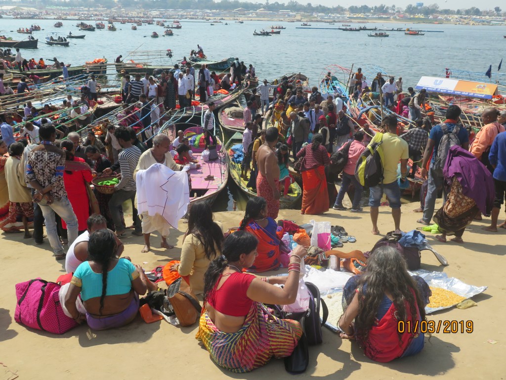 People basking in the sun on the banks of the ganges