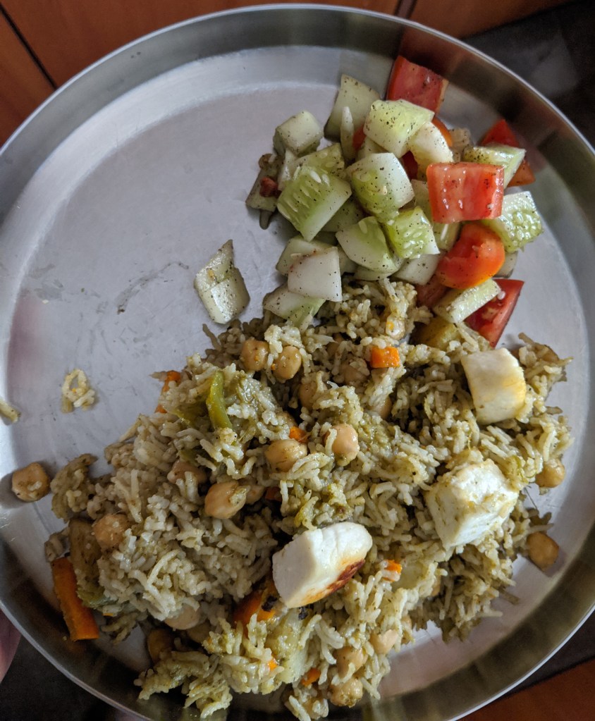 Chhole Paneer pulao with some salad of cucumber and tomatoes