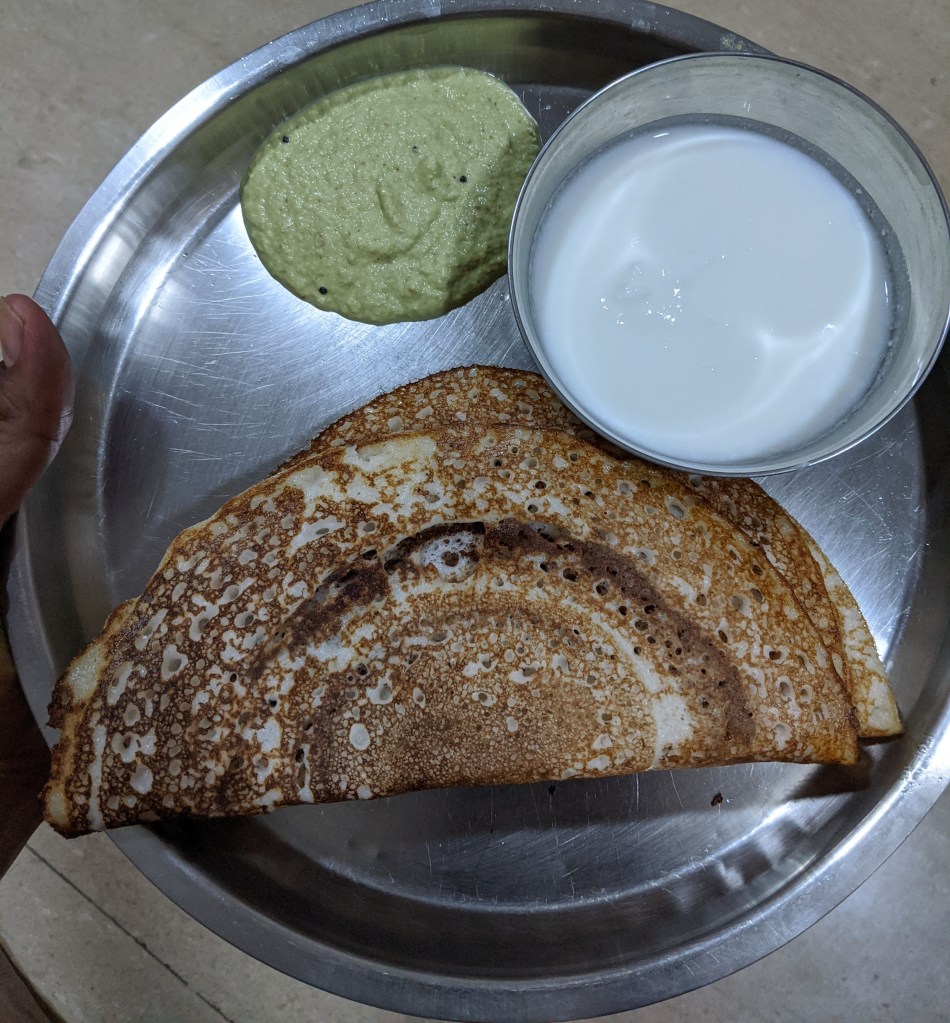 THe Idly dough transformed in to a dosa dough. Dosas accompanied with coconut chutney and curd
