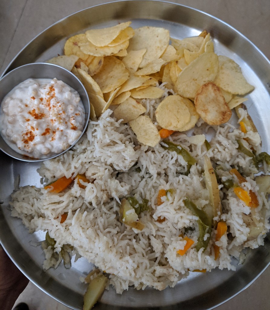 Vegetable pulav with boondi raita and potato chips